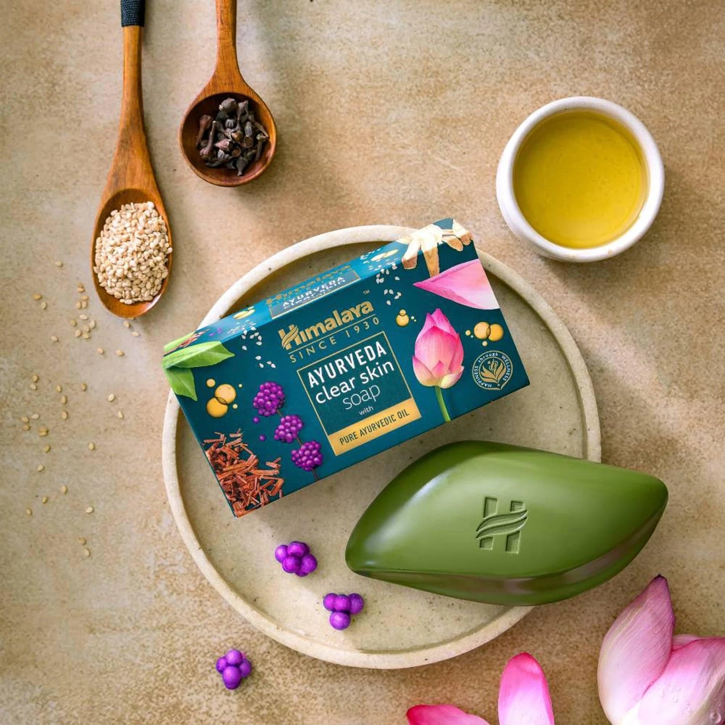 Himalaya Ayurveda soap bar on a plate with packaging and ingredients on a beige background