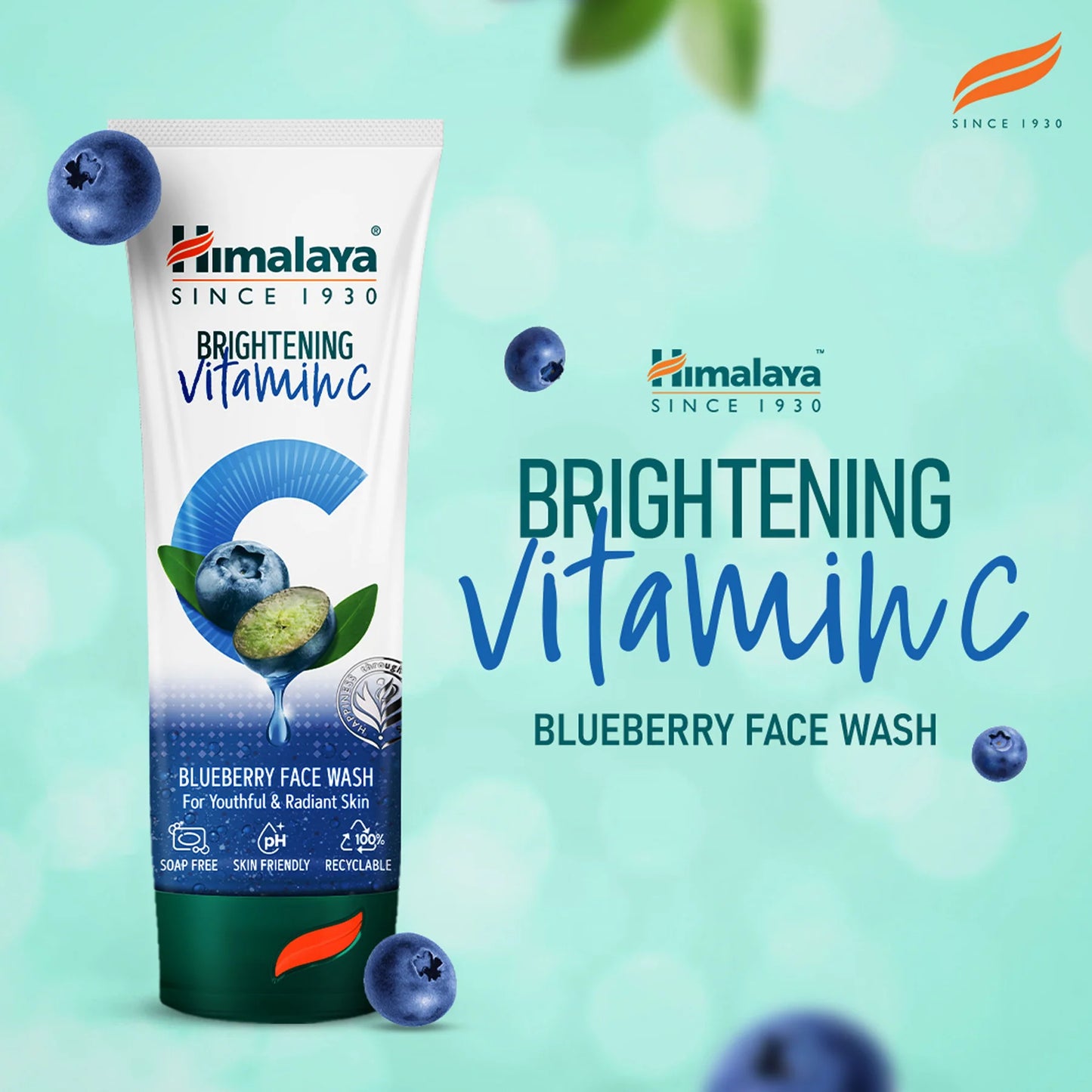 Himalaya Brightening Vitamin C Blueberry Face Wash tube on a light blue background with blueberries.